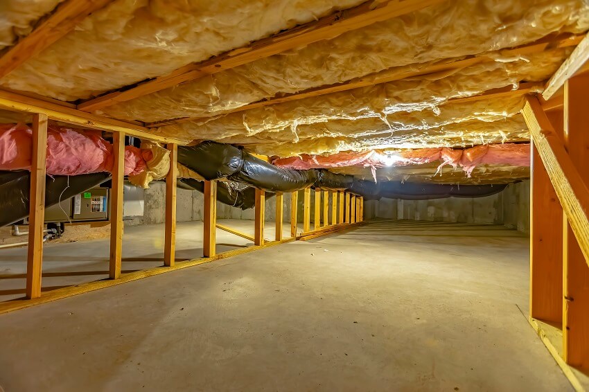 Lighted crawl space with upper floor insulation wooden support beams and concrete floor