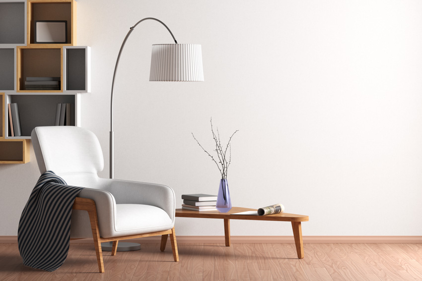 Living room area modern chair lamp shelf wood floor white wall