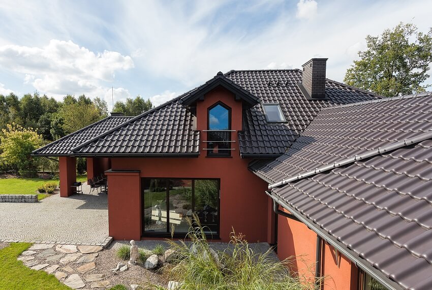 Mansion with black tile roof chimney garden and driveway