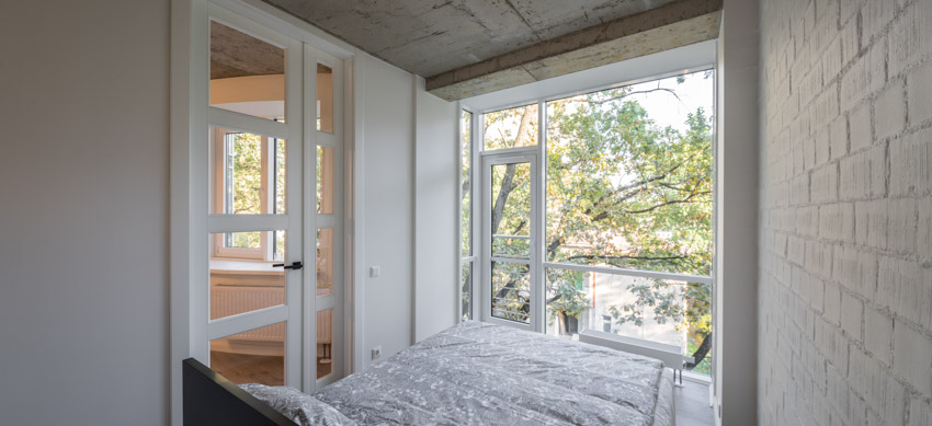 Masters bedroom with glass pivot door balcony