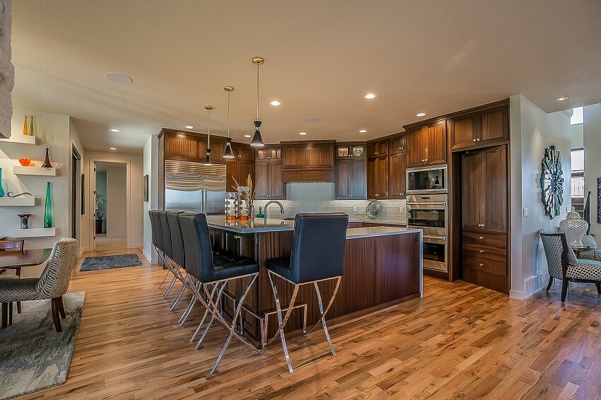 Mid century modern style kitchen with hardwood flooring and rich brown wood cabin