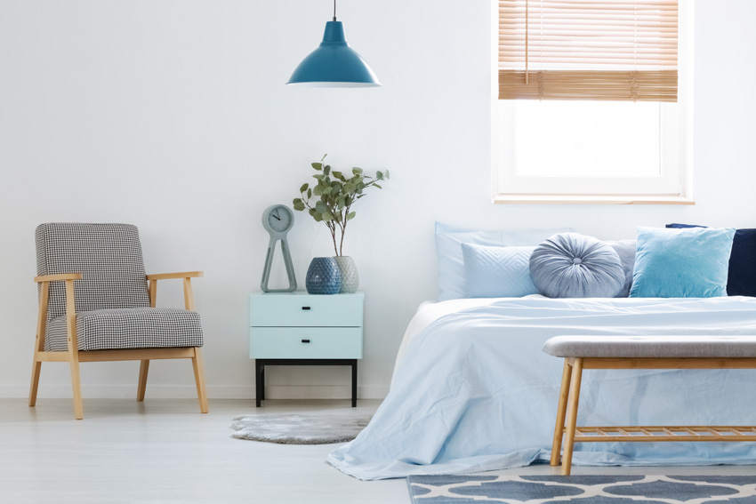 Minimalist bedroom blue nightstand window hanging light chair