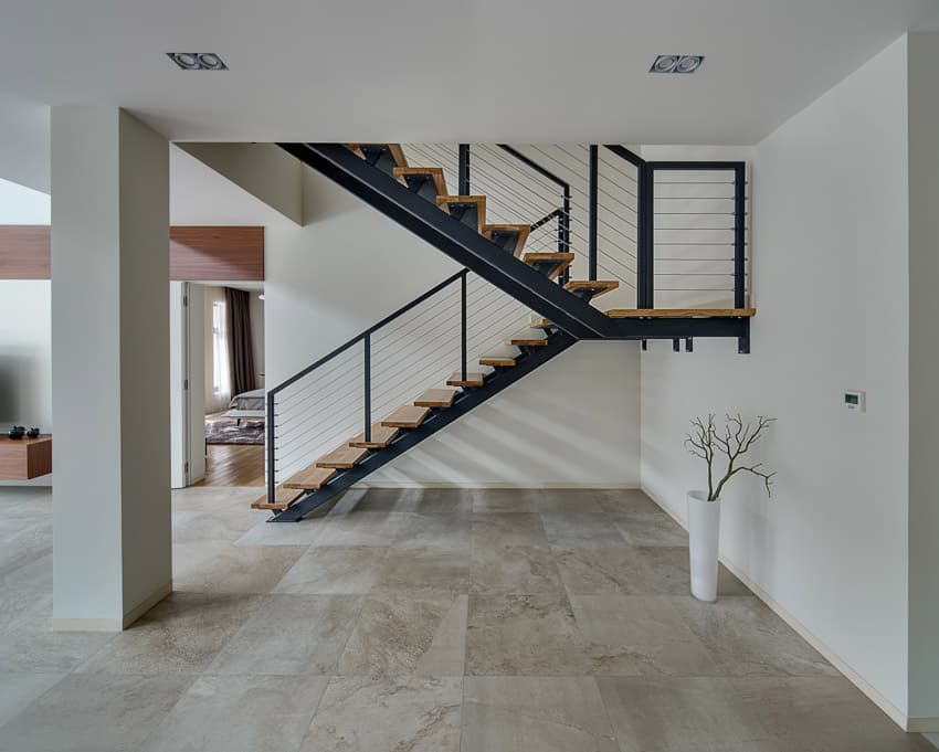 Minimalist staircase black and wood tile flooring white wall