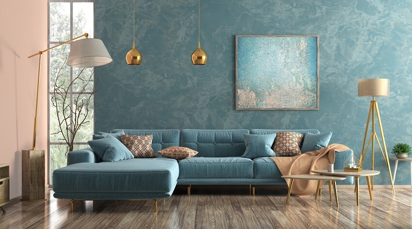 Modern interior of living room with blue corner sofa coffee tables floor lamp