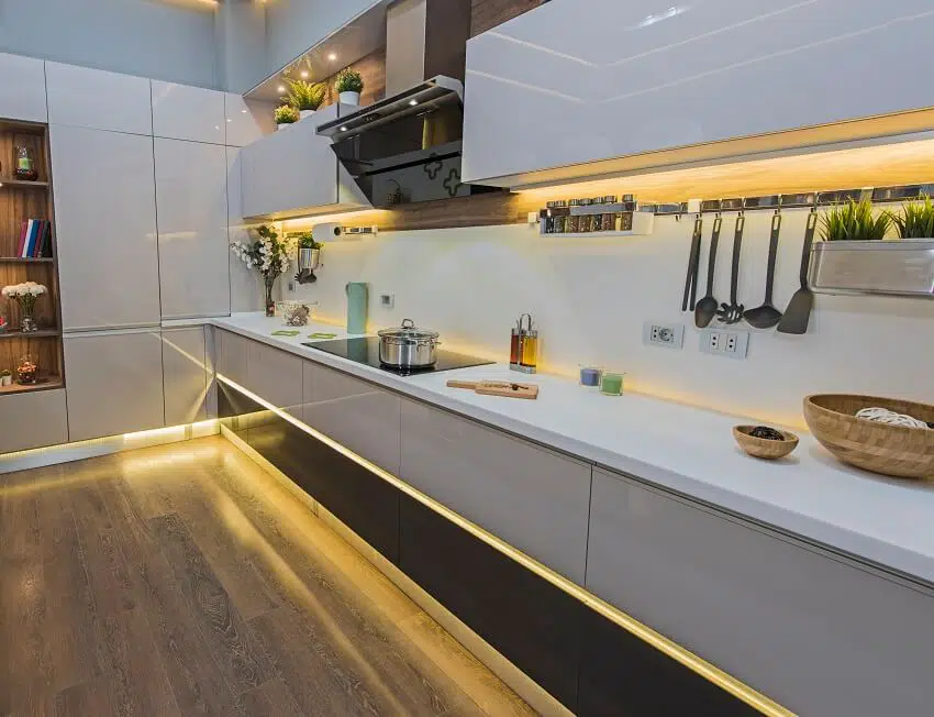 Modern kitchen with appliances and under cabinet lighting in luxury apartment