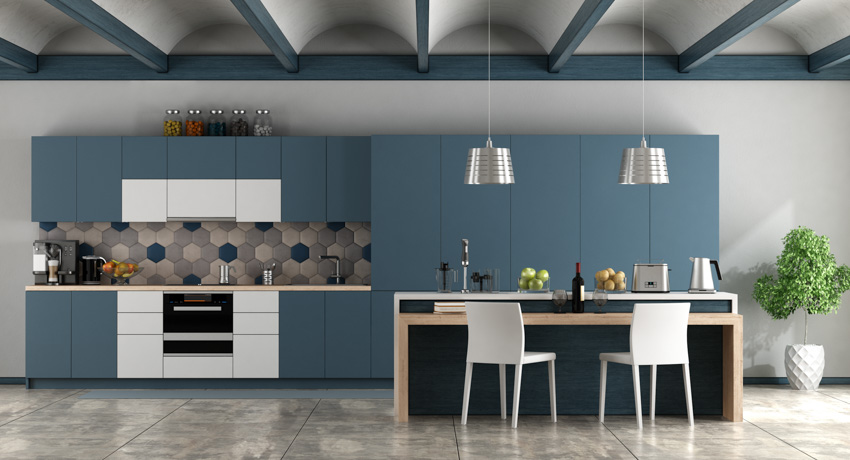 Modern kitchen with blue and white cabinets backsplash hanging lights center island chairs coffered ceiling