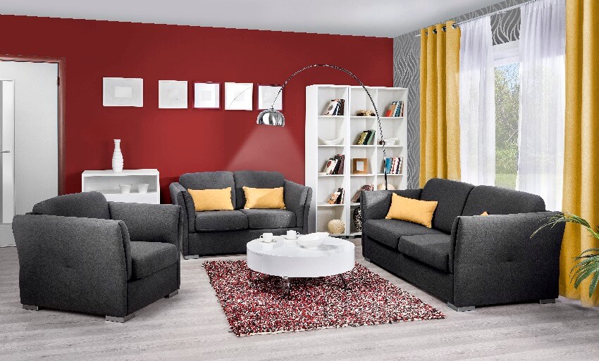 Modern living room with black sofa coffee table books in open shelves yellow curtain carpet in grey floors and maroon walls
