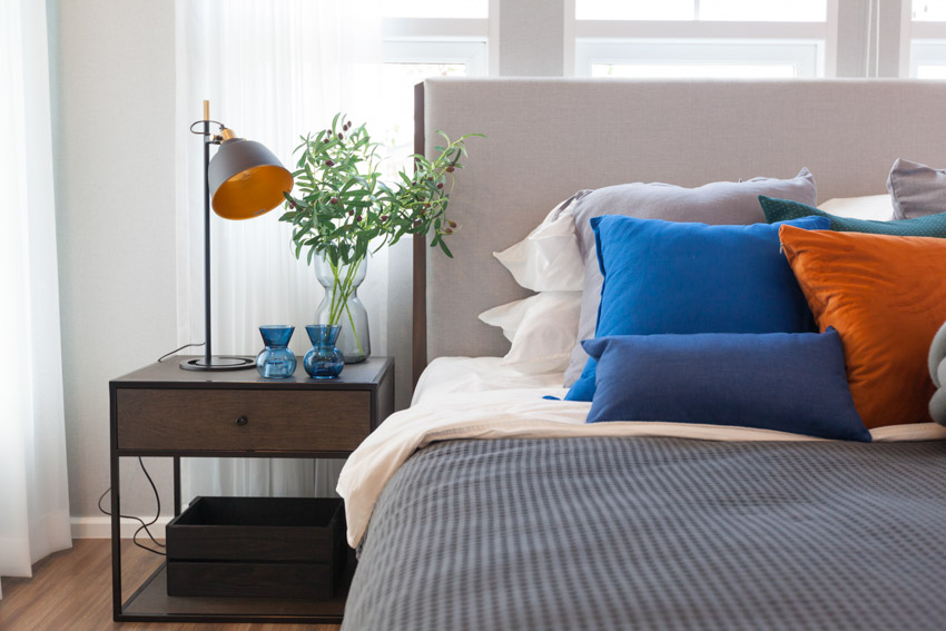Nightstand decor essentials lamp plant bed headboard wood flooring curtain