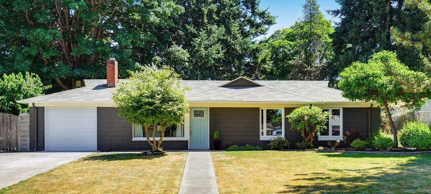 One level ranch house exterior with garage and concrete walkway