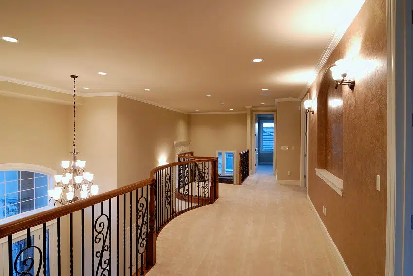 Hallway paint ideas of a home with light fixtures and railings