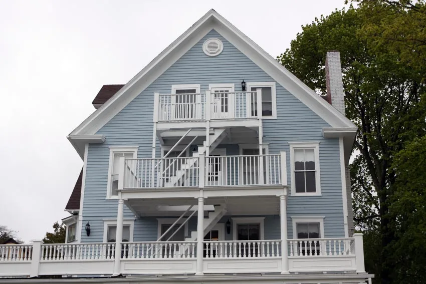 Pastel blue house exterior aluminum siding deck