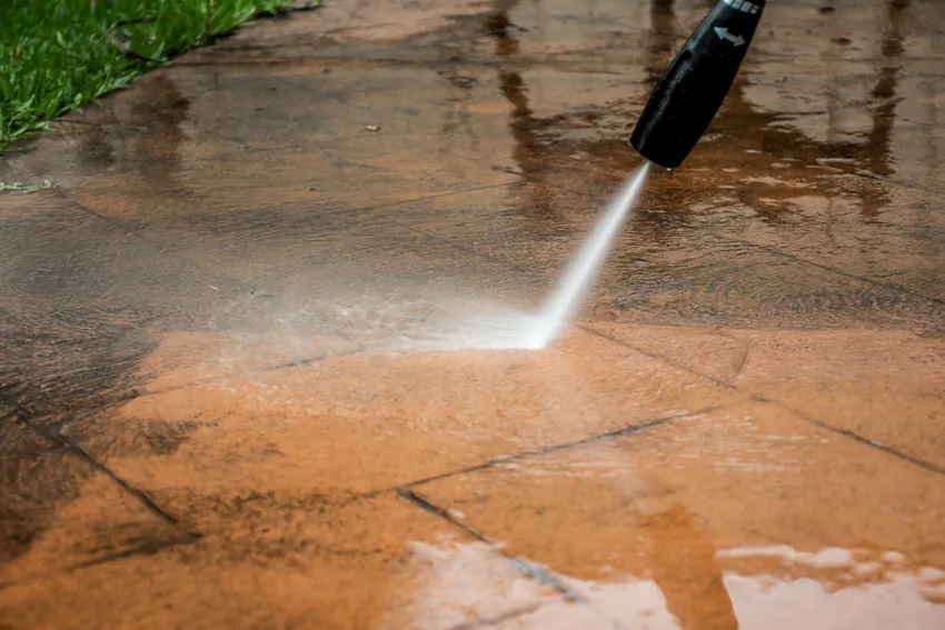 Pressure washer hose cleaning sandstone tiles