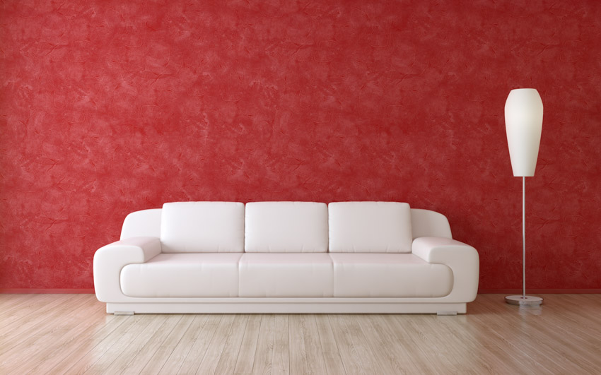 Red textured wall white couch modern lamp wood floor