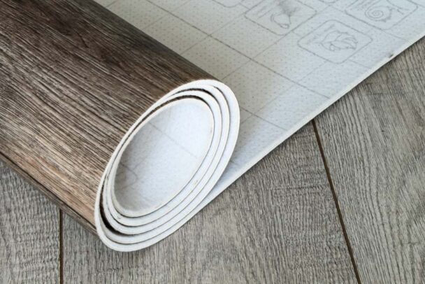Roll Of Linoleum Covering On Wood Floor Is 608x406 