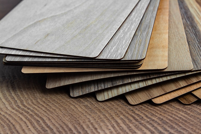 Sample of wood laminated chipboard for furniture design on wooden background
