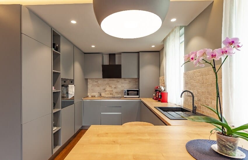 Grey modern kitchen in a luxury apartment with stainless steel appliances