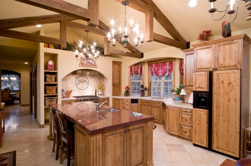Timber frame kitchen ceiling beam wood cabinets center island chandelier windows countertop
