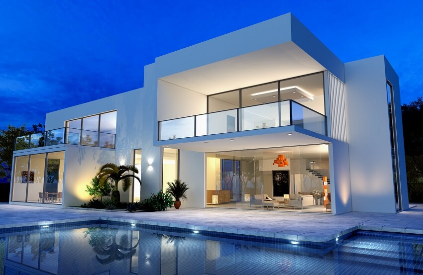 Two story white villa with open living room swimming pool floor to ceiling glass doors and balconies