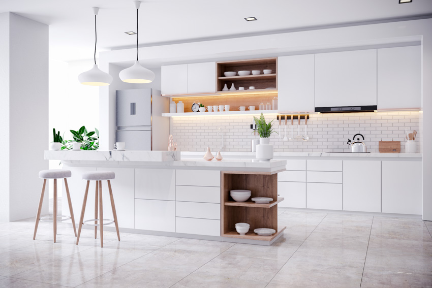 White kitchen with linoleum flooring center island with stools backsplash windows