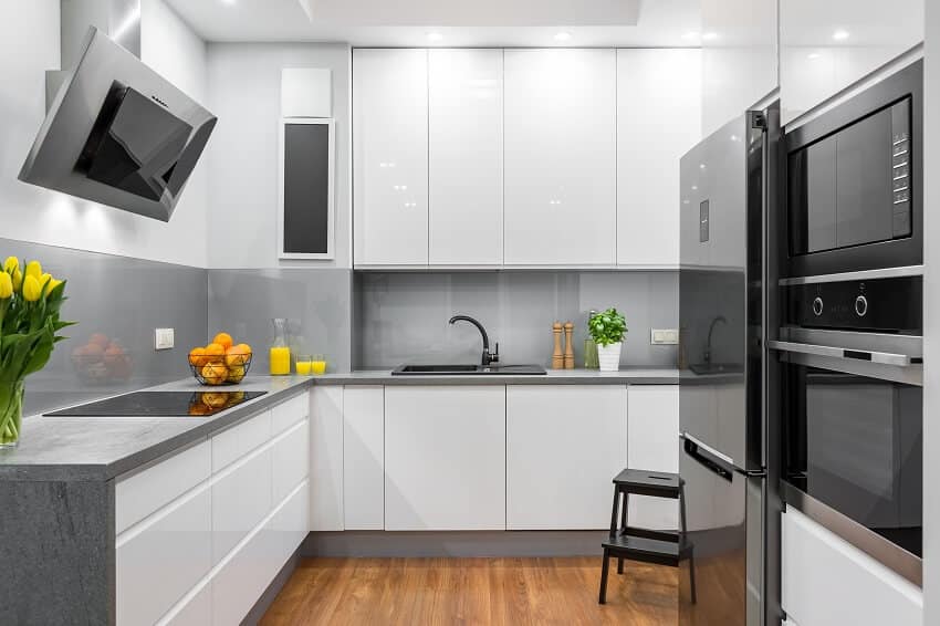 White kitchen with solid surface countertop and floor panels