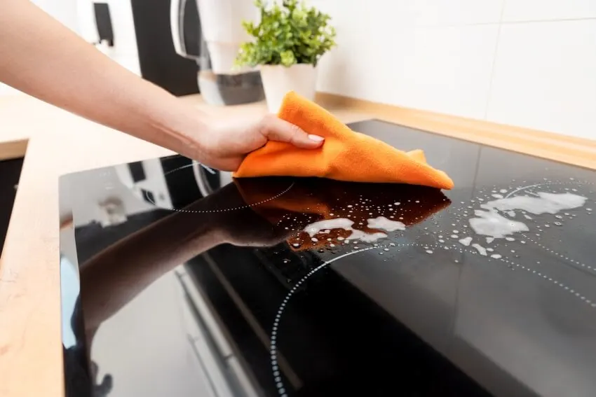 Woman cleaning induction stove