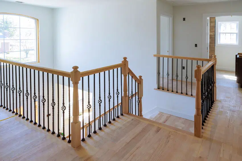 Wood floors wooden stair railing white staircase wall windows