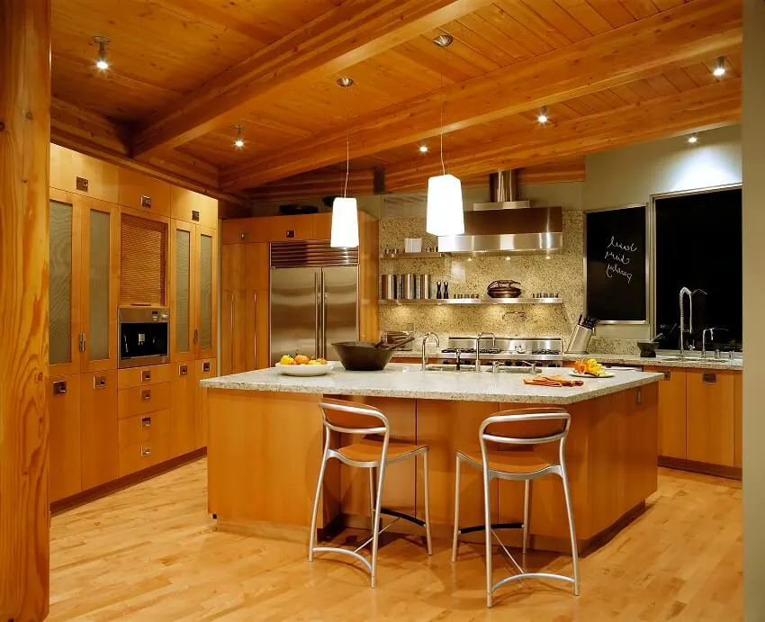Wooden kitchen interior with island granite backsplash and countertops bar stools pendant lights stainless steel appliance and ceiling beams