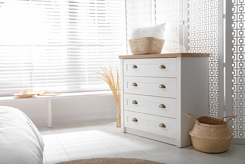 Elegant white room with chest drawer window shutters