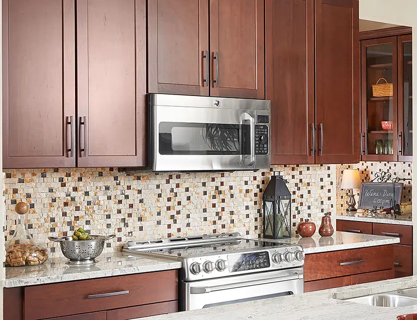 Kitchen with brown cabinets and mosaic backsplash