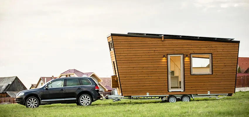 Tiny house on wheels with wooden exterior walls