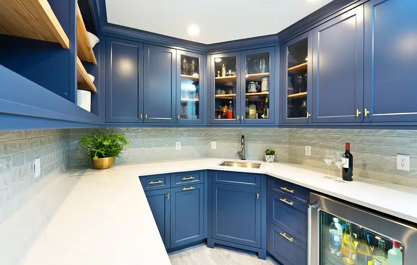 A contemporary butler's kitchen pantry room with wine storage cabinet bar sink blue cabinets brick backsplash and various pantry storage
