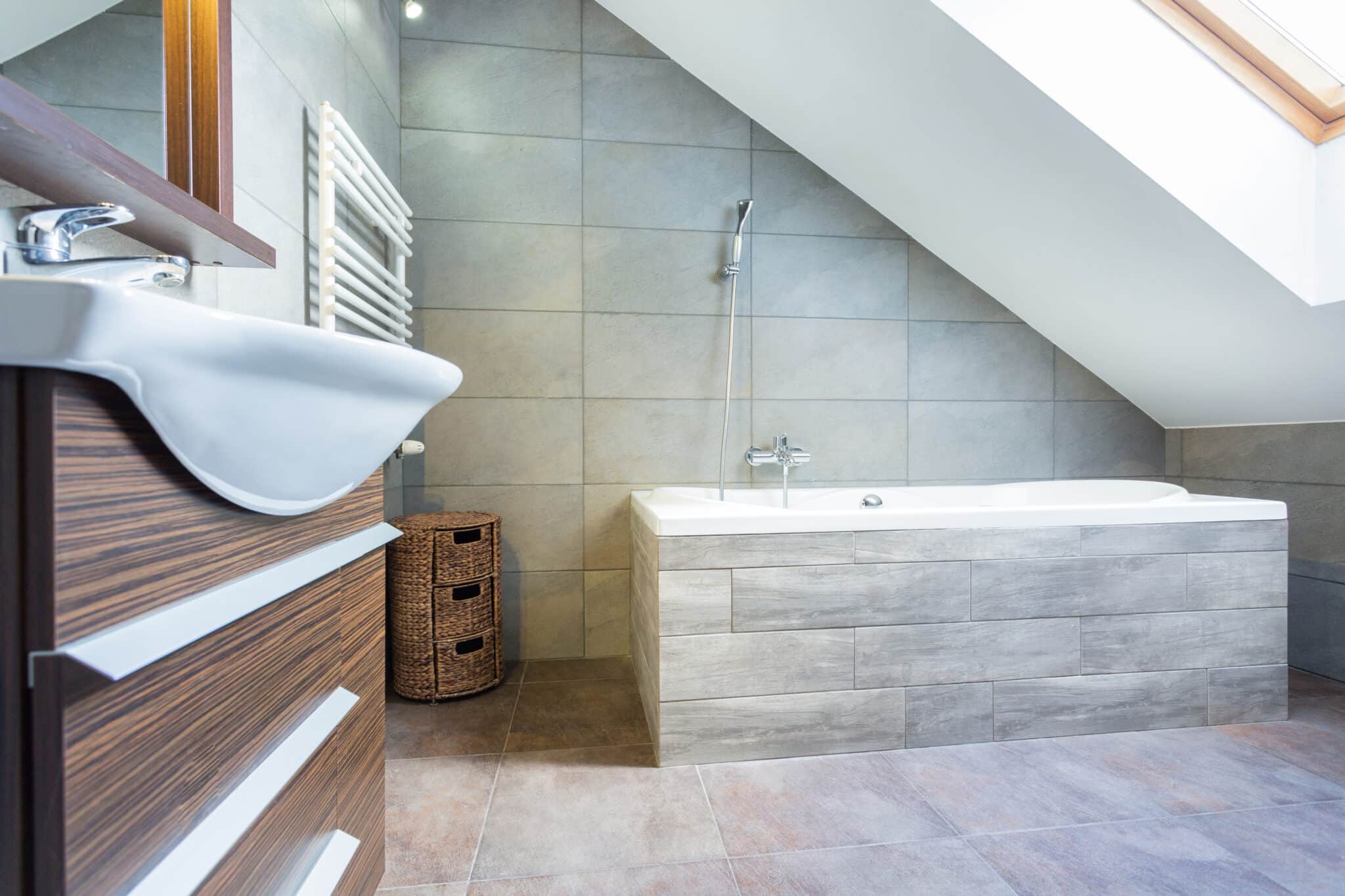 Attic bathroom skylight tub tile floor walls showerhead mirror drawer