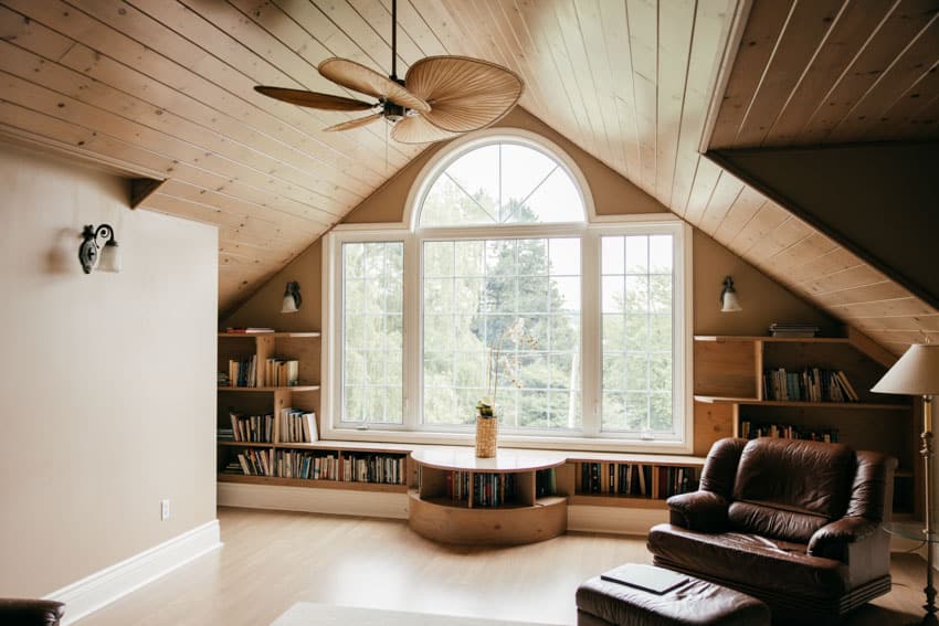 Attic room with wood ceiling and fan 