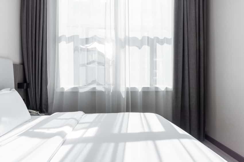 Bedroom gray blackout and white sheer curtain windows