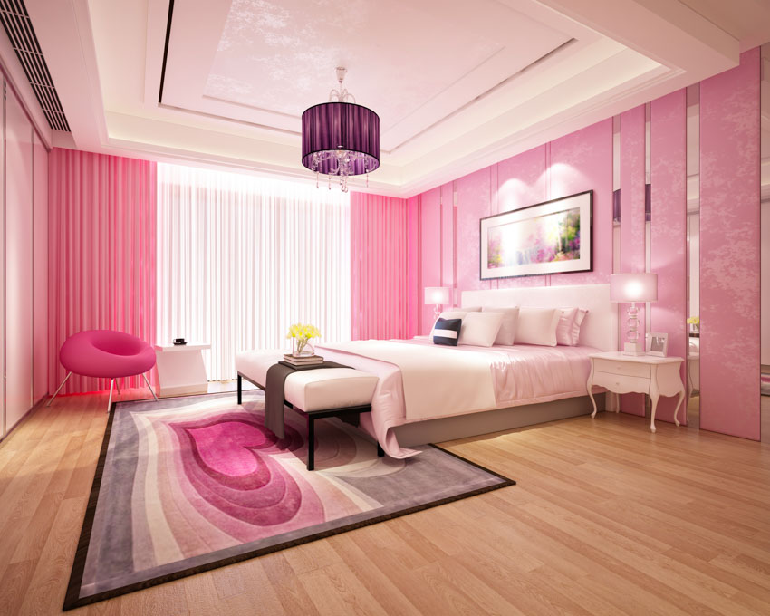 Bedroom pink curtains walls pendant light coffered ceiling nightstand chair wood floor rug