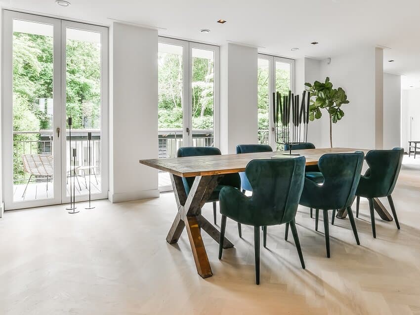 Bright area with velvet chairs, floor to ceiling doors and view of the deck