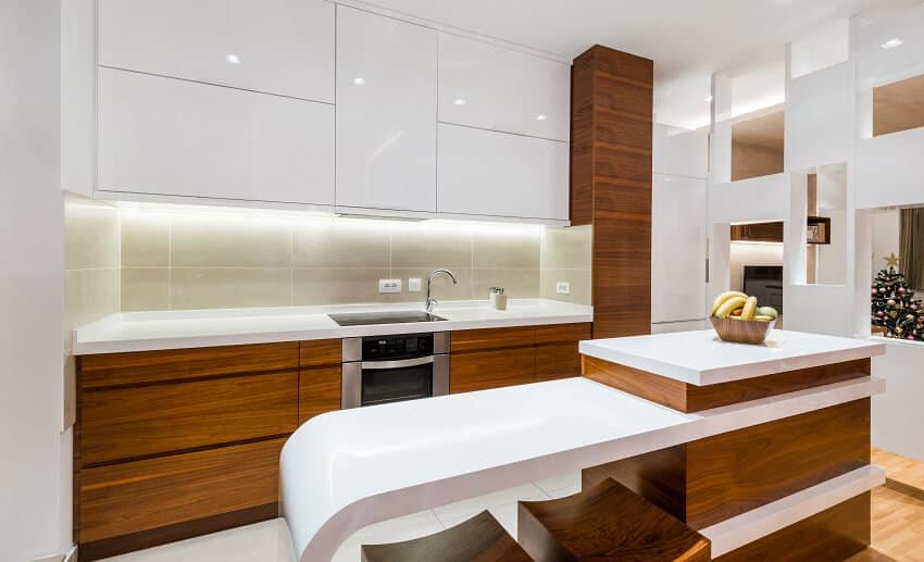 Brown and white luxury kitchen interior with cabinets range tile backsplash and island with wood bar stools