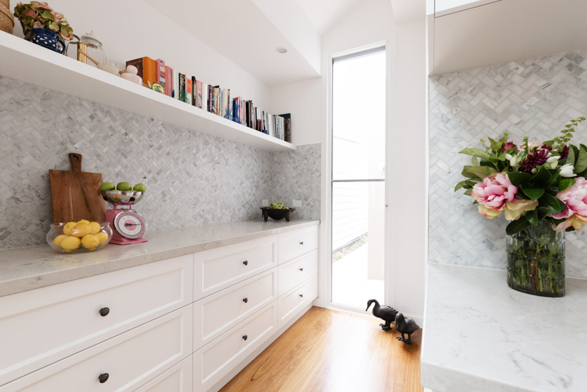 Butlers pantry design white drawers shelf herringbone tile backsplash wood floor