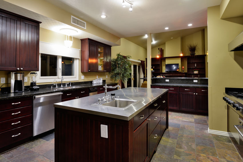 Classic kitchen with center island aluminum countertop tile floor wood cabinets recessed lighting 