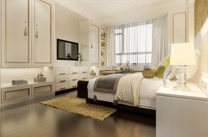 Classic white bedroom with chinese style wardrobe and closet hardwood floors patterned ceiling sheer curtains and mounted tv