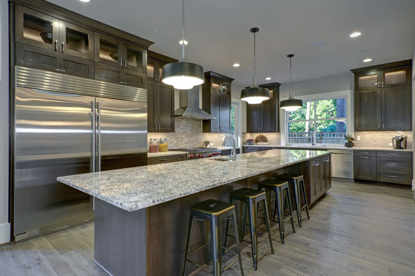 dolomite slab countertops kitchen, hanging light and stainless steel appliance backsplash