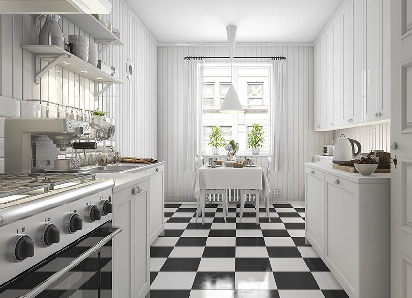 Farmhouse galley kitchen design with white cabinets, checkered black white floor tile, and beadboard walls