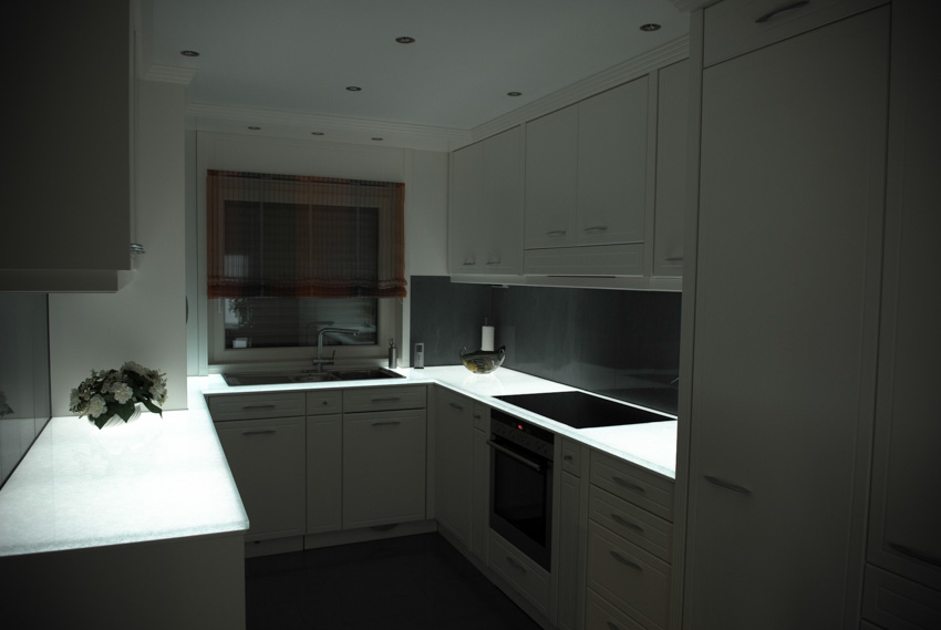 Glowing countertop in kitchen white cabinets