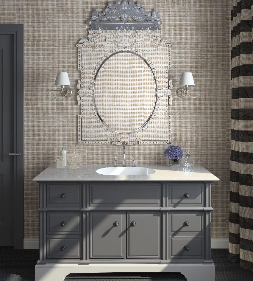 Grey cabinets a sink a striped curtain and lighting fixtures in a bathroom