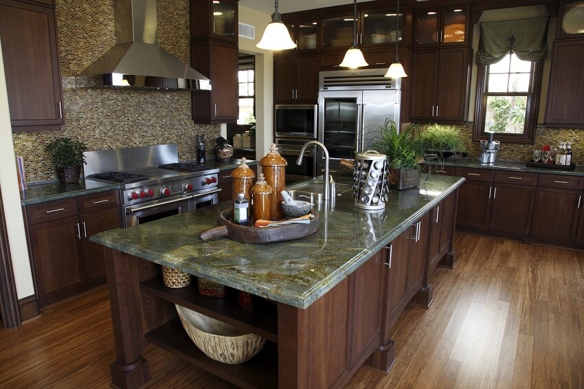 Home kitchen with a hardwood floor decors on granite island dark wood cabinets pendant lights and mosaic tile backsplash