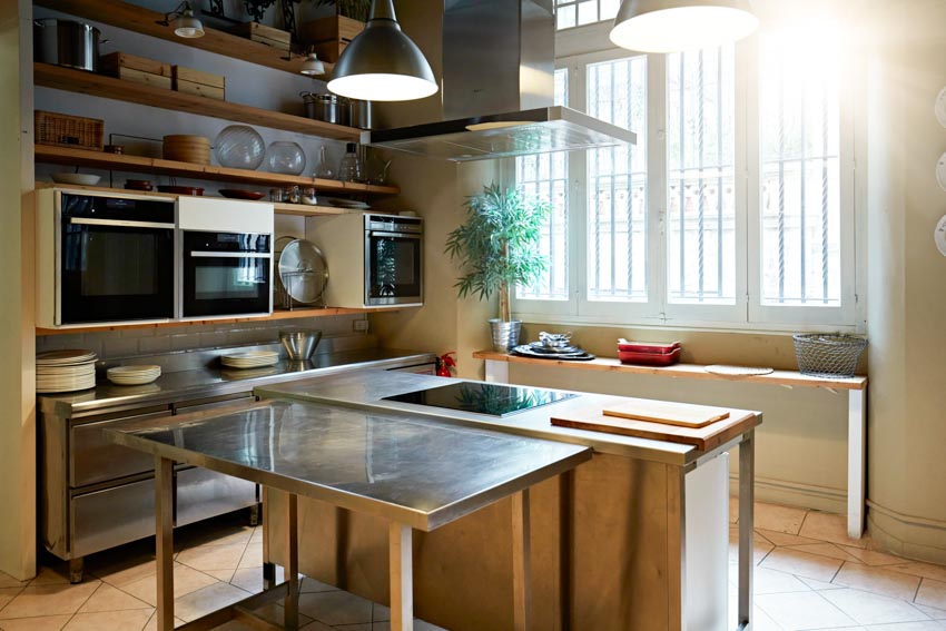 Kitchen with tin countertop windows pendant light shelves oven
