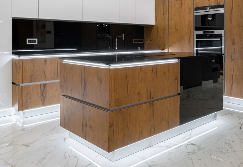Kitchen with translucent and backlit black countertop wood center island backsplash marble floor 