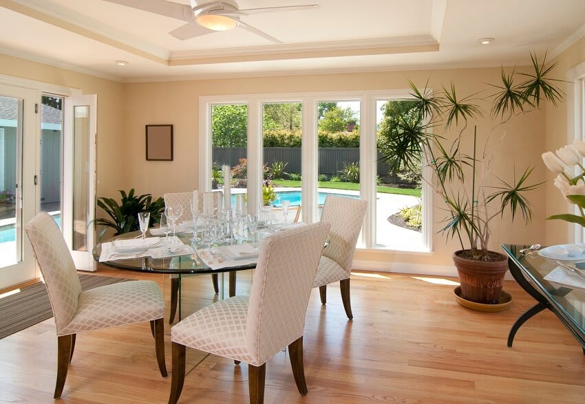 Light filled dining room with a glass table and chairs 