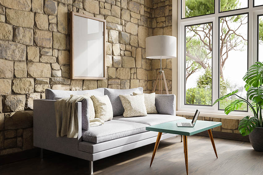 Living room with floor lamp stone wall light grey couch