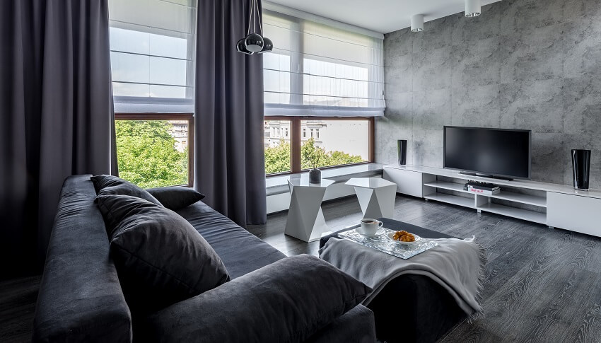 Living room with white furniture decors dark grey curtains and sofa glass windows white shade grey wall and dark wood floors